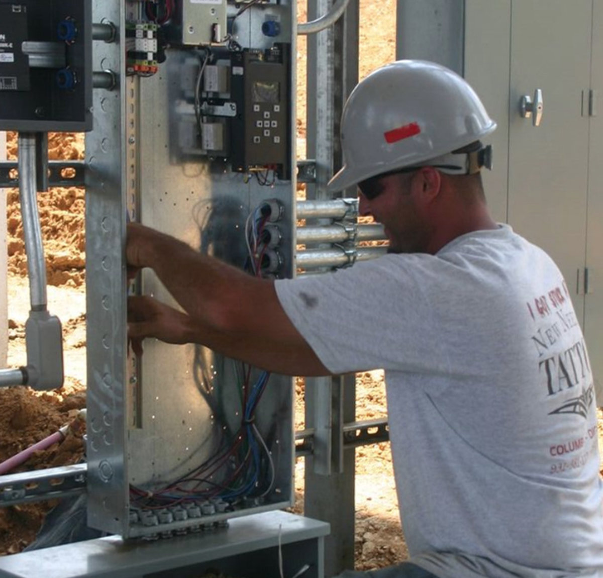 Amprite electrician working an equipment panel on an emergency service call
