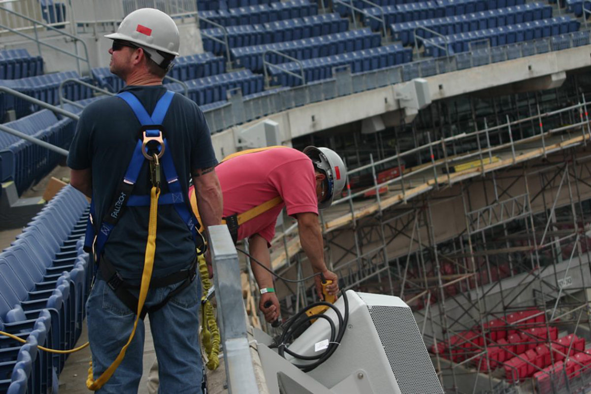 Working at height on the stadium structure during the sound system installation
