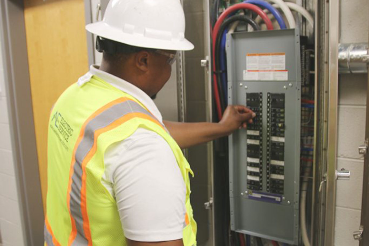 Amprite electrician terminating a panelboard at Paragon Mills Elementary