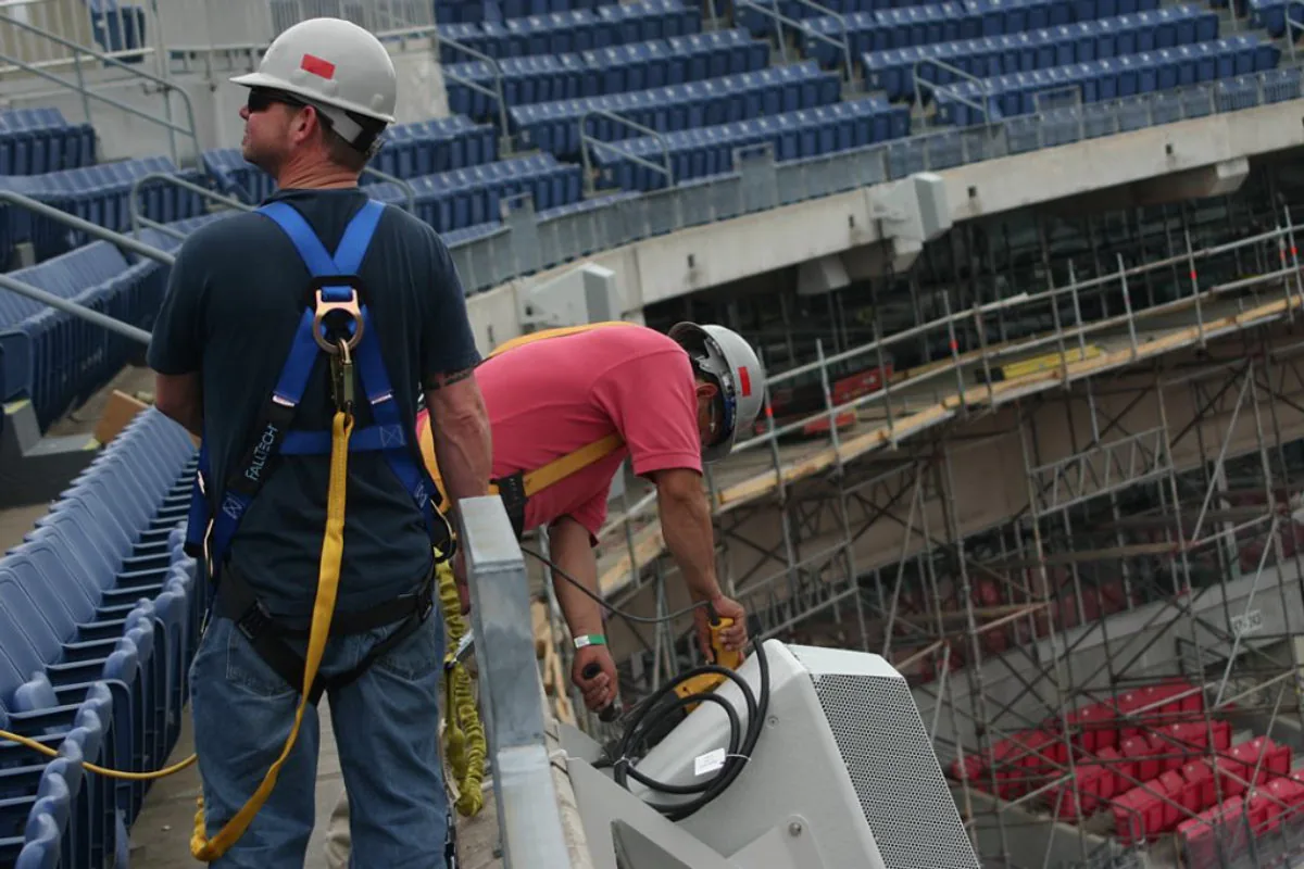 Working at height on the stadium structure during the sound system installation