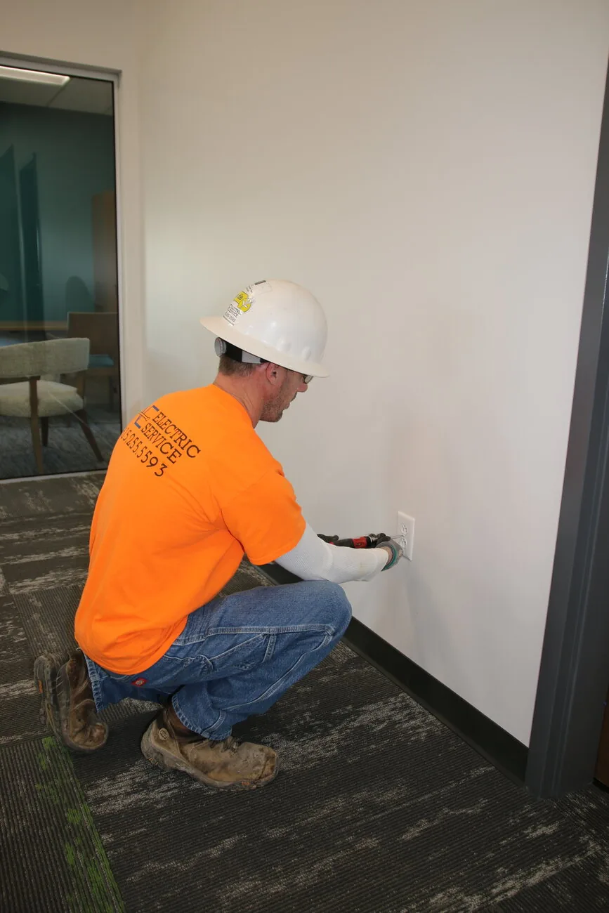 An Amprite Electric technician performing precise commercial electrical work in Nashville