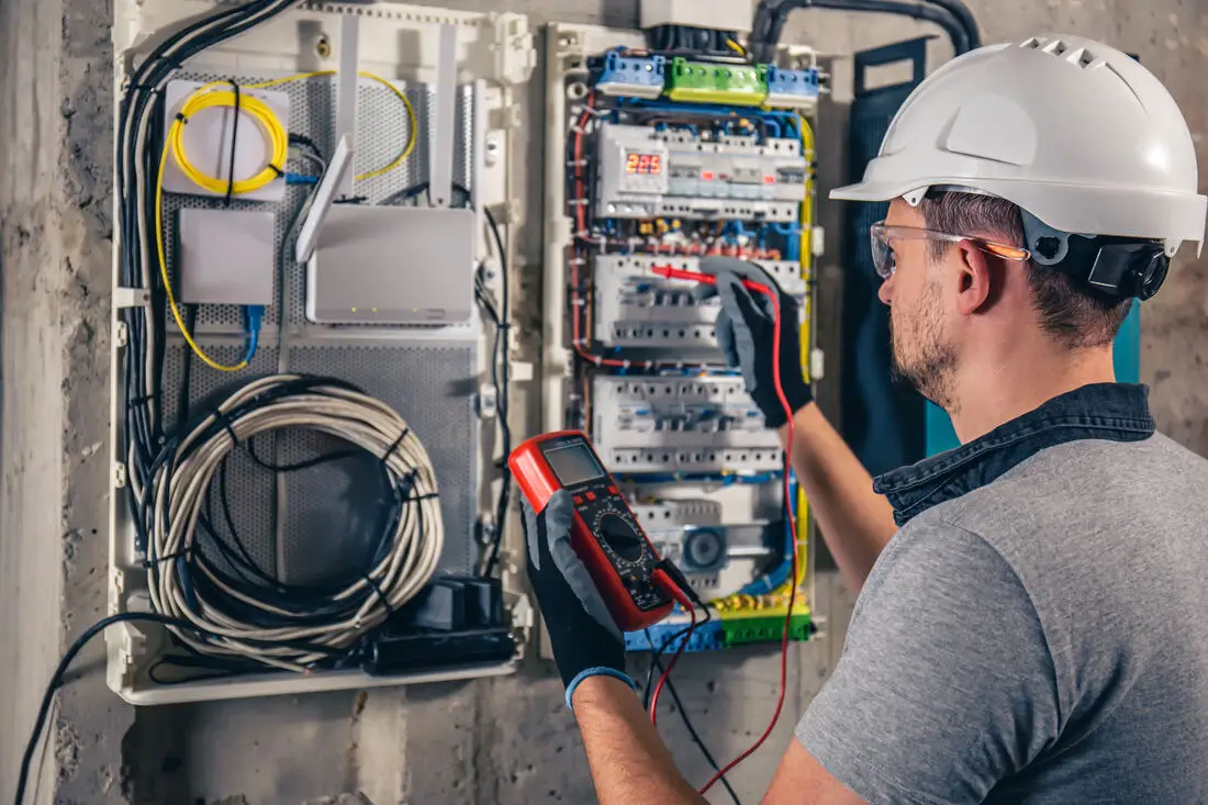 Amprite electrician testing circuits at a residential electrical panel
